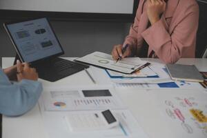 Close up of Business team analyzing income charts and graphs with modern laptop computer. Business analysis and strategy concept. photo
