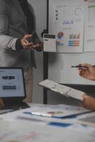 Close up of Business team analyzing income charts and graphs with modern laptop computer. Business analysis and strategy concept. photo