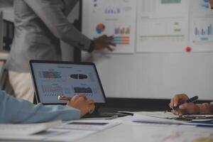 Close up of Business team analyzing income charts and graphs with modern laptop computer. Business analysis and strategy concept. photo