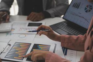 Close up of Business team analyzing income charts and graphs with modern laptop computer. Business analysis and strategy concept. photo