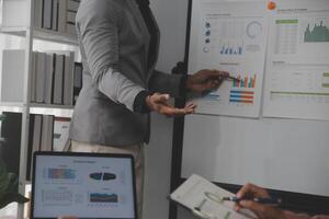 Close up of Business team analyzing income charts and graphs with modern laptop computer. Business analysis and strategy concept. photo