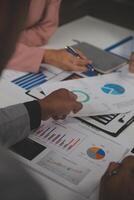 Close up of Business team analyzing income charts and graphs with modern laptop computer. Business analysis and strategy concept. photo
