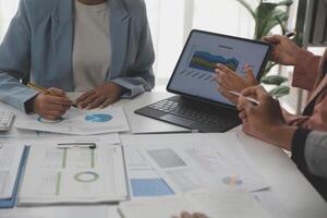 Close up of Business team analyzing income charts and graphs with modern laptop computer. Business analysis and strategy concept. photo
