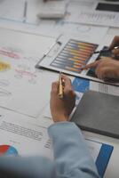 Close up of Business team analyzing income charts and graphs with modern laptop computer. Business analysis and strategy concept. photo