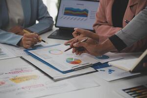 Close up of Business team analyzing income charts and graphs with modern laptop computer. Business analysis and strategy concept. photo