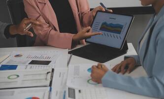 Close up of Business team analyzing income charts and graphs with modern laptop computer. Business analysis and strategy concept. photo