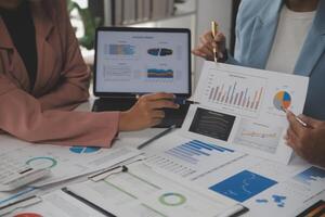 Close up of Business team analyzing income charts and graphs with modern laptop computer. Business analysis and strategy concept. photo