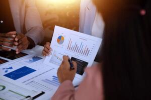 Close up of Business team analyzing income charts and graphs with modern laptop computer. Business analysis and strategy concept. photo
