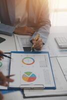 Close up of Business team analyzing income charts and graphs with modern laptop computer. Business analysis and strategy concept. photo