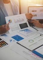 Close up of Business team analyzing income charts and graphs with modern laptop computer. Business analysis and strategy concept. photo