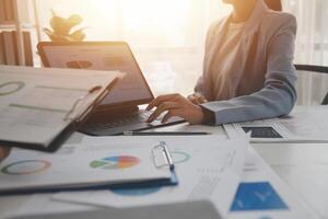 Close up of Business team analyzing income charts and graphs with modern laptop computer. Business analysis and strategy concept. photo