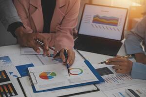 Close up of Business team analyzing income charts and graphs with modern laptop computer. Business analysis and strategy concept. photo