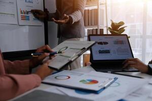 Close up of Business team analyzing income charts and graphs with modern laptop computer. Business analysis and strategy concept. photo
