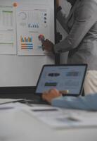 Close up of Business team analyzing income charts and graphs with modern laptop computer. Business analysis and strategy concept. photo