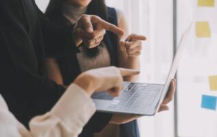 Financial analysts analyze business financial reports on a digital tablet planning investment project during a discussion at a meeting of corporate showing the results of their successful teamwork. photo