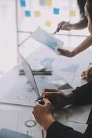 Financial analysts analyze business financial reports on a digital tablet planning investment project during a discussion at a meeting of corporate showing the results of their successful teamwork. photo