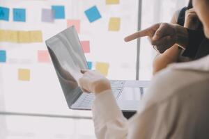 Financial analysts analyze business financial reports on a digital tablet planning investment project during a discussion at a meeting of corporate showing the results of their successful teamwork. photo