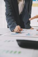 Financial analysts analyze business financial reports on a digital tablet planning investment project during a discussion at a meeting of corporate showing the results of their successful teamwork. photo