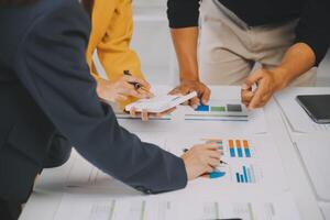 Financial analysts analyze business financial reports on a digital tablet planning investment project during a discussion at a meeting of corporate showing the results of their successful teamwork. photo
