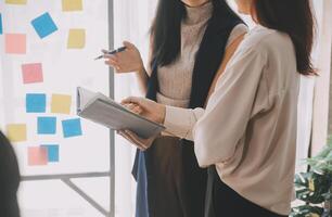 Financial analysts analyze business financial reports on a digital tablet planning investment project during a discussion at a meeting of corporate showing the results of their successful teamwork. photo