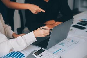 Financial analysts analyze business financial reports on a digital tablet planning investment project during a discussion at a meeting of corporate showing the results of their successful teamwork. photo