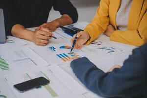 Financial analysts analyze business financial reports on a digital tablet planning investment project during a discussion at a meeting of corporate showing the results of their successful teamwork. photo
