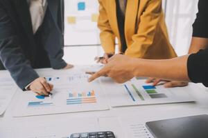 Financial analysts analyze business financial reports on a digital tablet planning investment project during a discussion at a meeting of corporate showing the results of their successful teamwork. photo