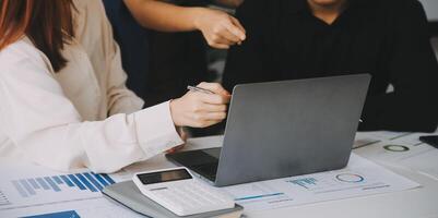Financial analysts analyze business financial reports on a digital tablet planning investment project during a discussion at a meeting of corporate showing the results of their successful teamwork. photo