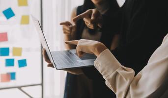 Financial analysts analyze business financial reports on a digital tablet planning investment project during a discussion at a meeting of corporate showing the results of their successful teamwork. photo