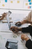 Financial analysts analyze business financial reports on a digital tablet planning investment project during a discussion at a meeting of corporate showing the results of their successful teamwork. photo