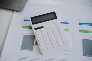 Financial analysts analyze business financial reports on a digital tablet planning investment project during a discussion at a meeting of corporate showing the results of their successful teamwork. photo