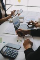 Financial analysts analyze business financial reports on a digital tablet planning investment project during a discussion at a meeting of corporate showing the results of their successful teamwork. photo