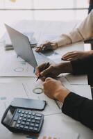 Financial analysts analyze business financial reports on a digital tablet planning investment project during a discussion at a meeting of corporate showing the results of their successful teamwork. photo