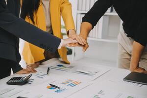 Financial analysts analyze business financial reports on a digital tablet planning investment project during a discussion at a meeting of corporate showing the results of their successful teamwork. photo