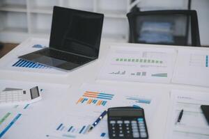 Financial analysts analyze business financial reports on a digital tablet planning investment project during a discussion at a meeting of corporate showing the results of their successful teamwork. photo