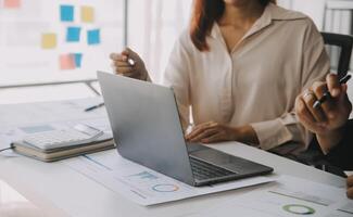 Financial analysts analyze business financial reports on a digital tablet planning investment project during a discussion at a meeting of corporate showing the results of their successful teamwork. photo