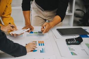 Financial analysts analyze business financial reports on a digital tablet planning investment project during a discussion at a meeting of corporate showing the results of their successful teamwork. photo