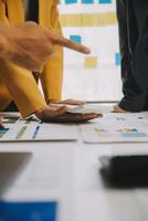 Financial analysts analyze business financial reports on a digital tablet planning investment project during a discussion at a meeting of corporate showing the results of their successful teamwork. photo