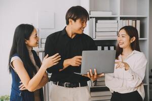 Financial analysts analyze business financial reports on a digital tablet planning investment project during a discussion at a meeting of corporate showing the results of their successful teamwork. photo