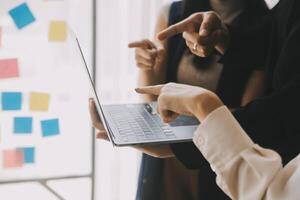 Financial analysts analyze business financial reports on a digital tablet planning investment project during a discussion at a meeting of corporate showing the results of their successful teamwork. photo