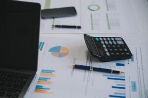 Financial analysts analyze business financial reports on a digital tablet planning investment project during a discussion at a meeting of corporate showing the results of their successful teamwork. photo