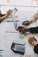 Financial analysts analyze business financial reports on a digital tablet planning investment project during a discussion at a meeting of corporate showing the results of their successful teamwork. photo