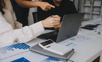 Financial analysts analyze business financial reports on a digital tablet planning investment project during a discussion at a meeting of corporate showing the results of their successful teamwork. photo