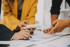 Financial analysts analyze business financial reports on a digital tablet planning investment project during a discussion at a meeting of corporate showing the results of their successful teamwork. photo