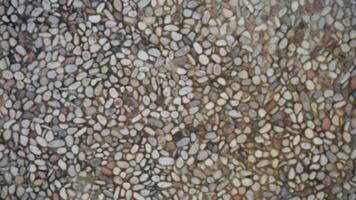 Abstract blurred background of pebble stone wall texture for design and decoration. photo