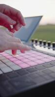 Hand Pressing Buttons on Music Controller with Pink Backlighting video