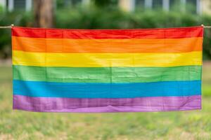 LGBT Pride Rainbow Flag Outdoors on Clothesline, Colorful Symbol of LGBTQ Community and Equality, Close-Up Horizontal View photo