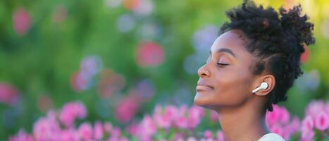 Tranquil Woman Enjoying Nature with Wireless Earbuds Blurred Garden Background Pink Flowers Greenery Summer Vibes photo