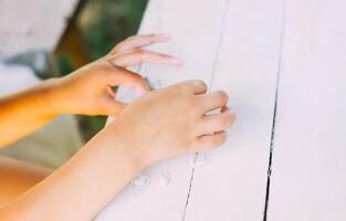 Kid hands in the process of creating the handicraft of polymer clay photo