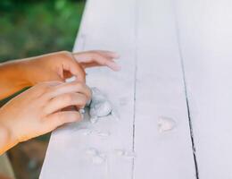 Kid hands in the process of creating the handicraft of polymer clay photo